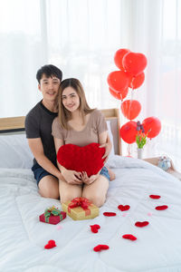 Young couple kissing with heart shape at home