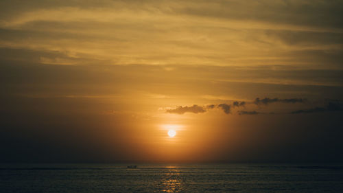 Scenic view of sea against romantic sky at sunset