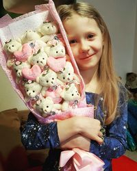 Portrait of smiling girl holding ice cream at home