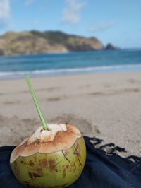 Close-up of apple on beach