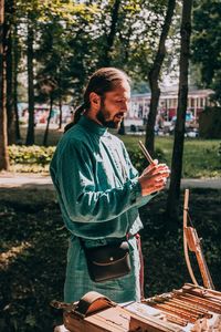 Full length of man standing against trees