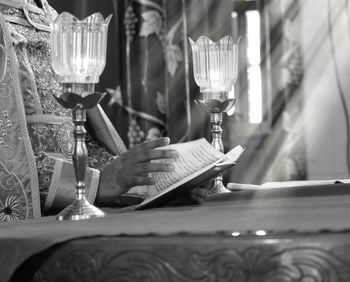 View of wine glasses on table at illuminated temple