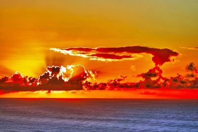 Scenic view of sea against romantic sky at sunset