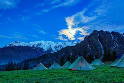 Scenic view of mountains against blue sky