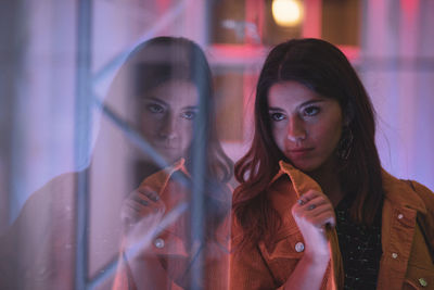 Reflection of young woman on glass