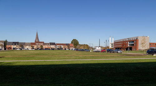 Scenic view of buildings against clear blue sky