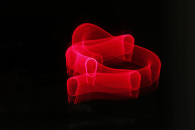 Close-up of red light painting against black background