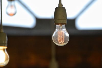 Close-up of light bulb hanging from water