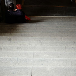 Low section of woman sitting outdoors