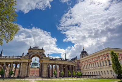 Low angle view of building against cloudy sky