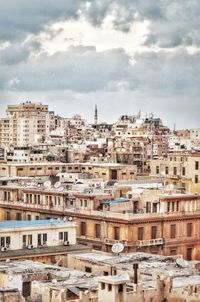 Cityscape against cloudy sky