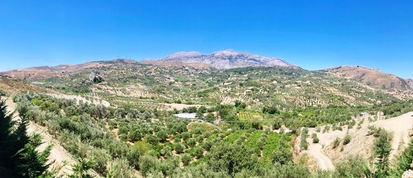 Scenic view of mountains against clear blue sky