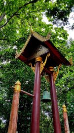 Low angle view of cross amidst trees in temple