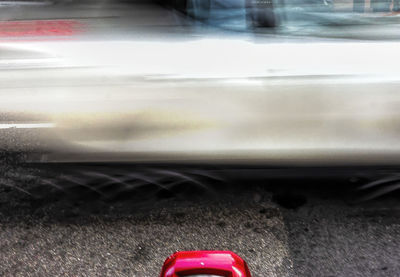 Close-up of car on road