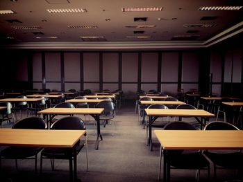 Empty chairs and tables in room, vintage or retro tone