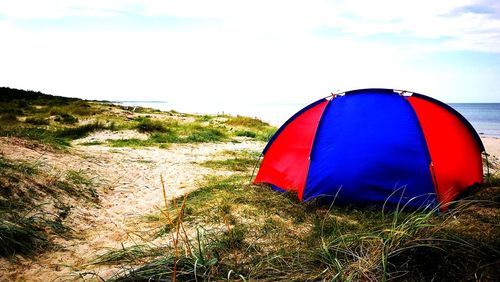 Tent on field against sky