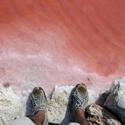 Low section of person standing on rock