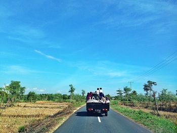 Cars on road against blue sky