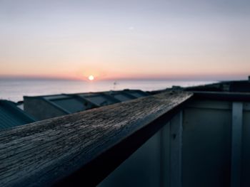 View of calm sea against sunset