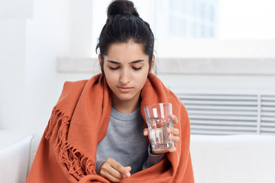 Beautiful young woman drinking drink