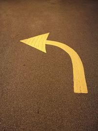 Yellow arrow symbol on road