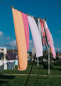 Colorful clothes hanging on line in garden