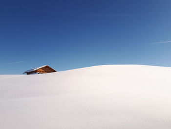 Snowcapped mountain against clear blue sky