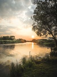 Scenic view of lake against sky during sunset