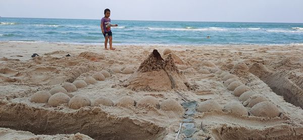 Full length of man on beach against sky