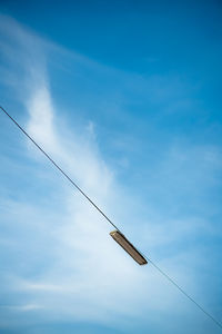 Low angle view of street light against blue sky