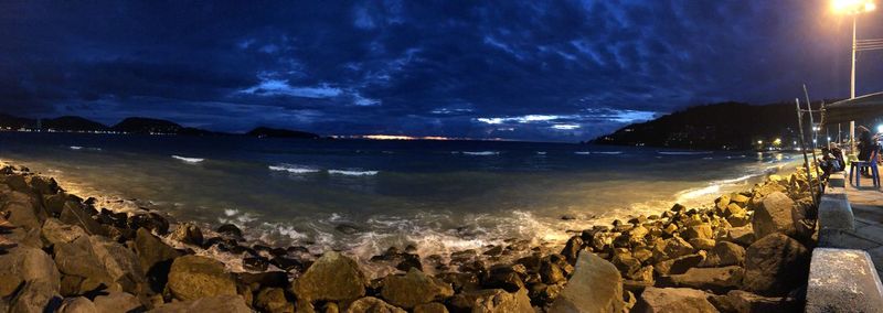 Panoramic view of beach against sky at night