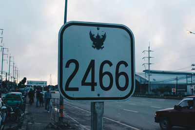 Road sign against sky