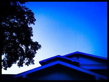 Low angle view of built structure against clear blue sky