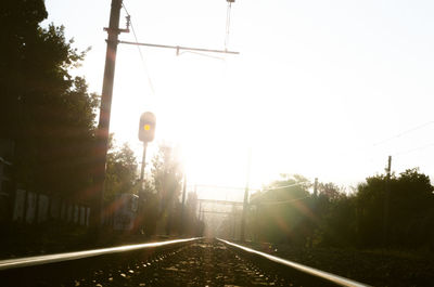 View of railway tracks and trees against clear sky