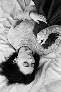 High angle view of woman lying on bed