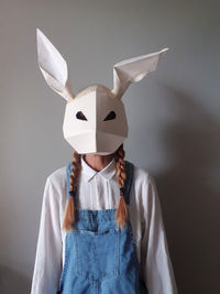 Woman wearing paper rabbit mask