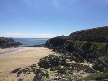 Scenic view of beach against clear blue sky