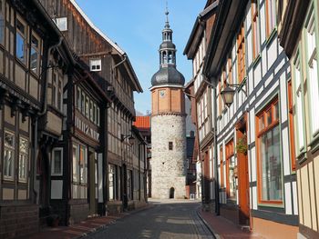 Street amidst buildings leading towards clock tower at stolberg