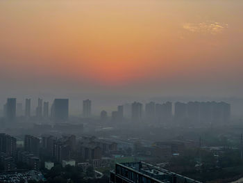 Cityscape against sky during sunset