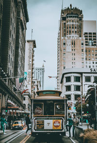 View of city street and buildings against sky