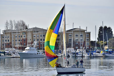 Sailboats in city against sky