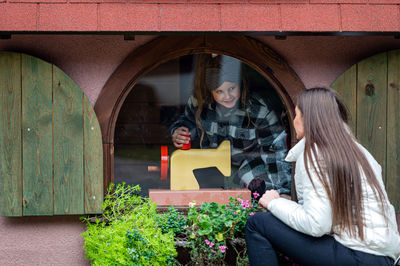 Woman standing at the entrance of a building