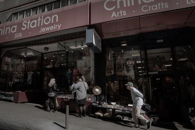 People working at store in city at night