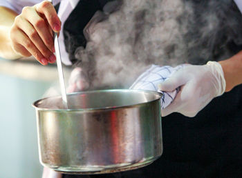 Cropped hand of person preparing food