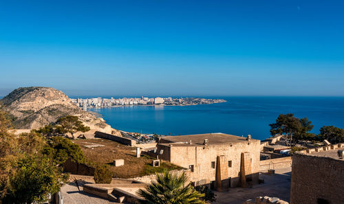 Town by sea against blue sky seen from santa barbara castle