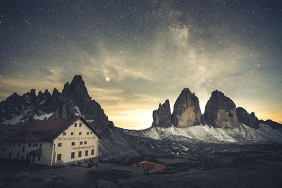 Panoramic view of snowcapped mountains against sky at night