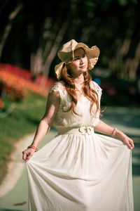 Young woman looking away against blurred background