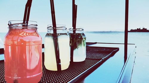 Close-up of three jars with liquid