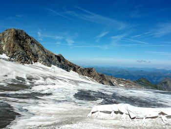 Scenic view of snowcapped mountain against blue sky