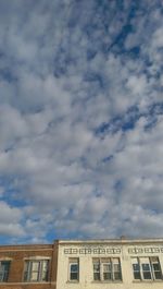 Low angle view of building against cloudy sky